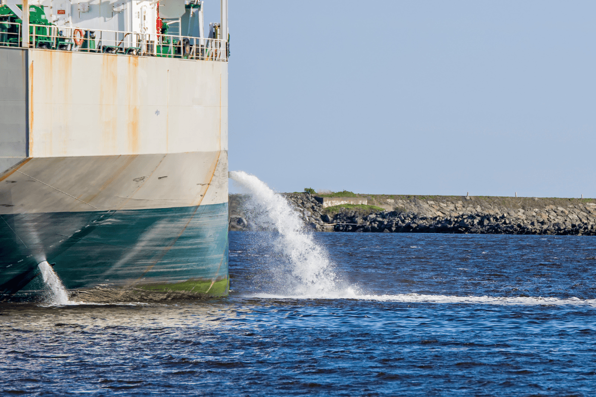 An image of a ship expelling water into the ocean.
