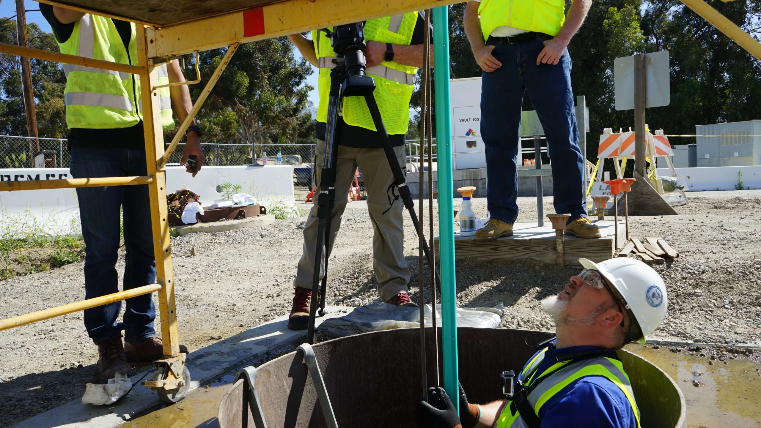 Image of flow meter installation by men in hard hats.
